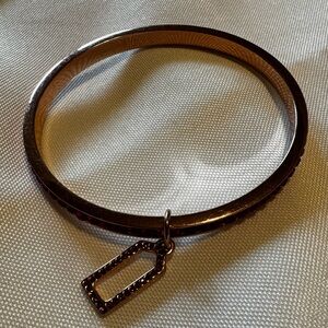 Coach rose gold bracelet with fushia stones.